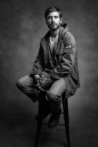 man in black leather jacket and pants sitting on seat