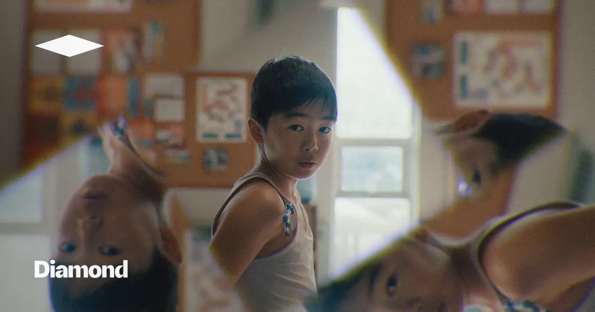 Young boy turning to look over his shoulder in a sunlit room