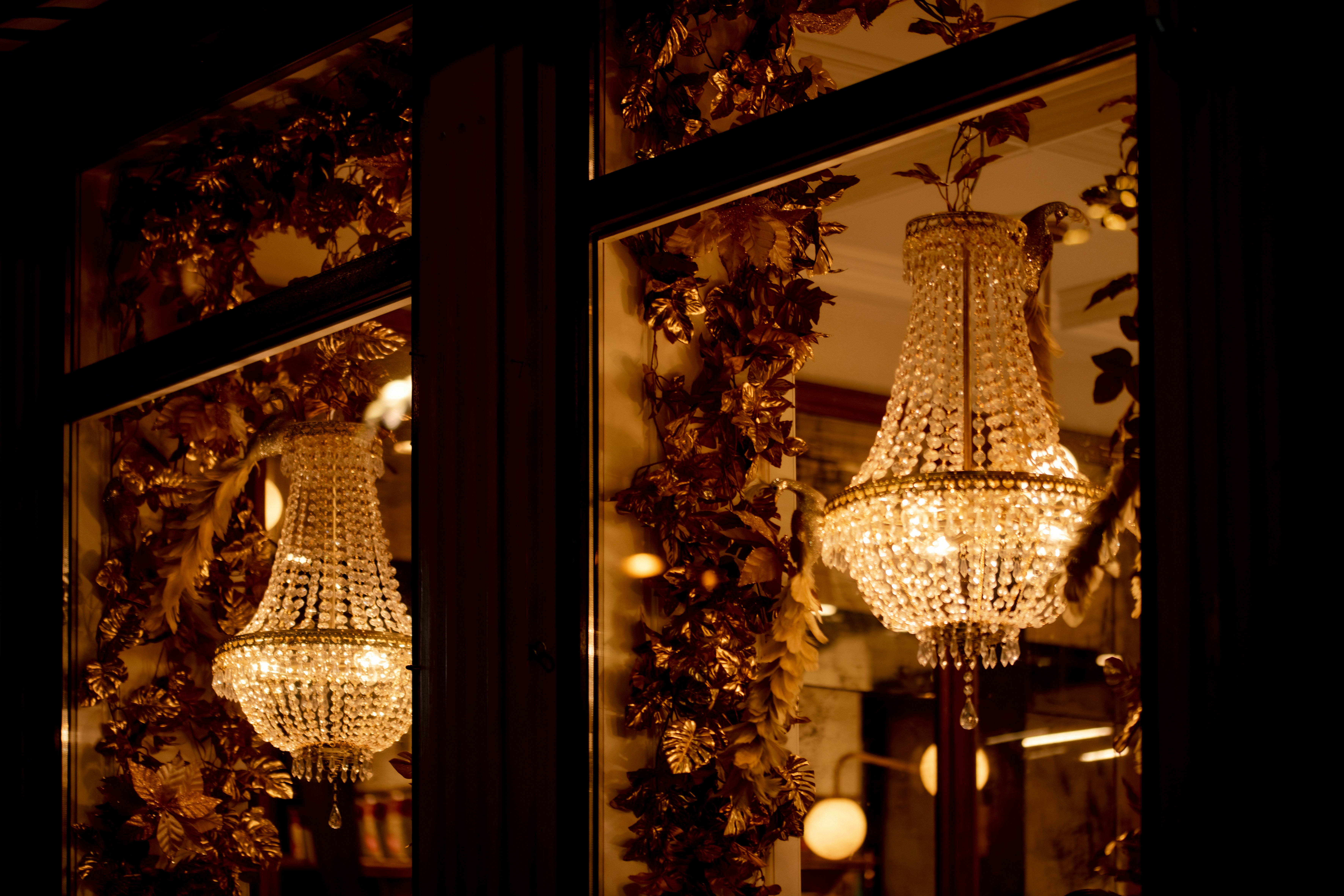 A chandelier viewed from a window, capturing light and interior details.