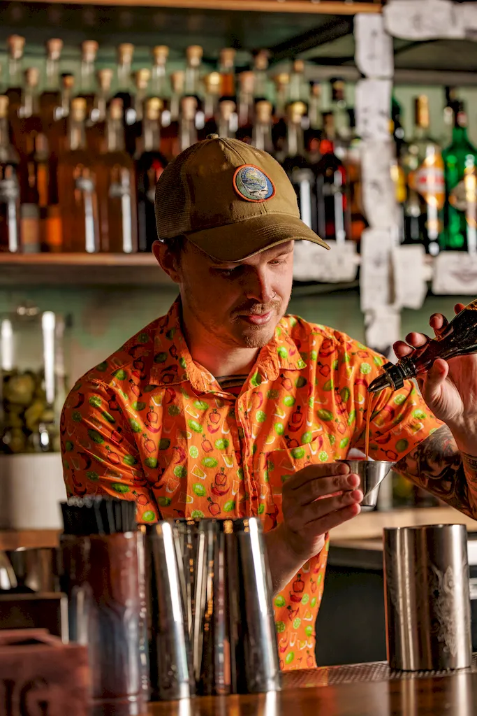 Company owner Aidan Wren meausring alcohol in a jigger