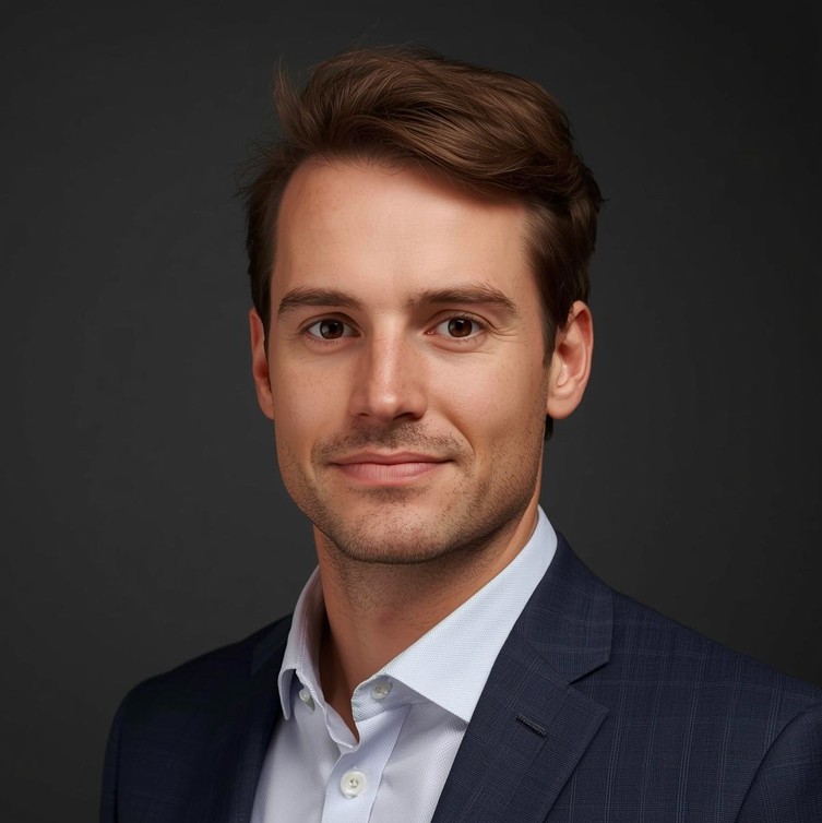 Man with brown hair wearing suit.