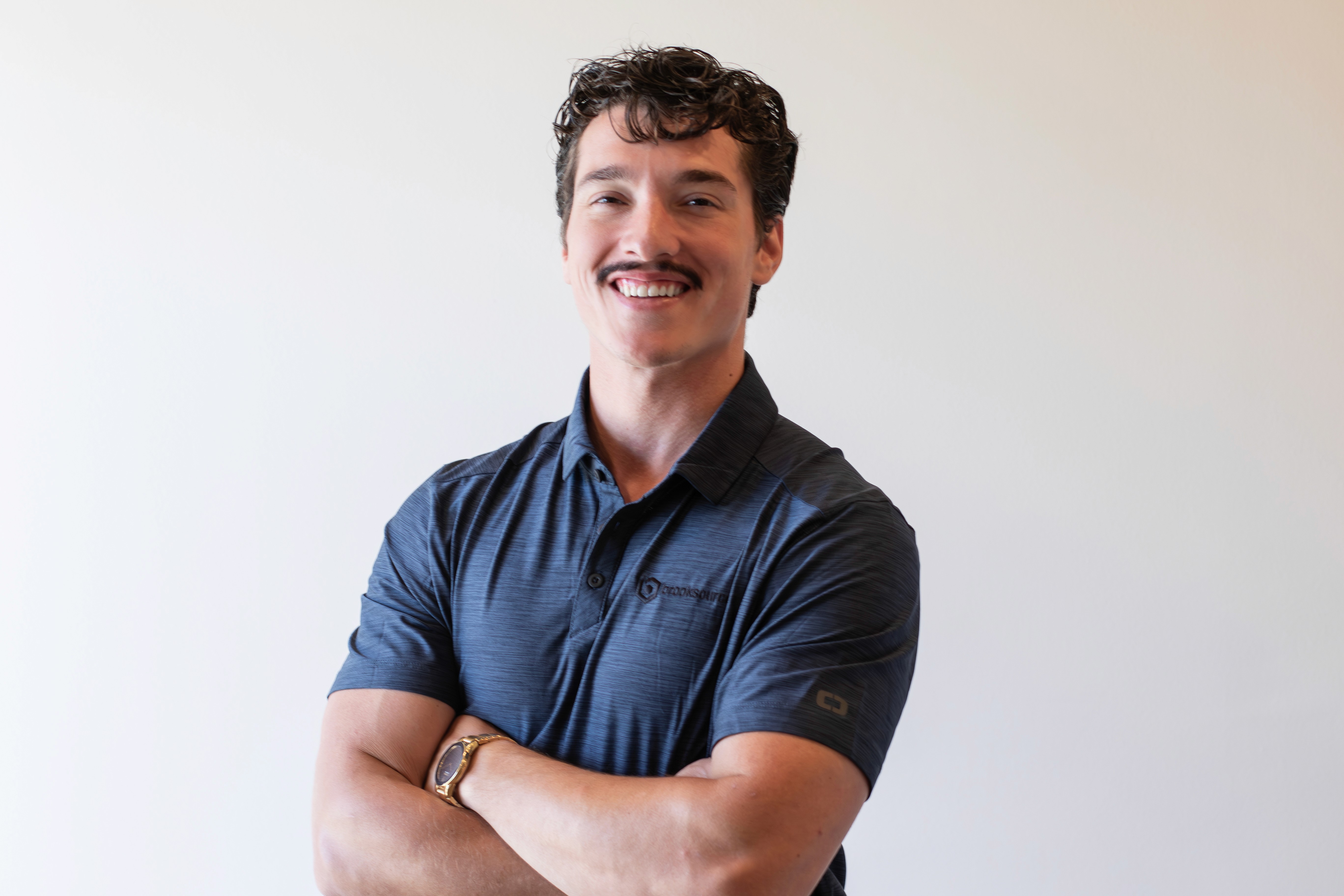 A headshot of a smiling female doctor.