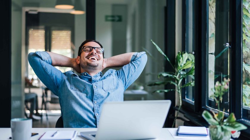 A man leaning back in his office chair. He looks really relaxed.