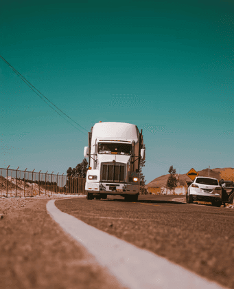 white freight truck on grey concrete road