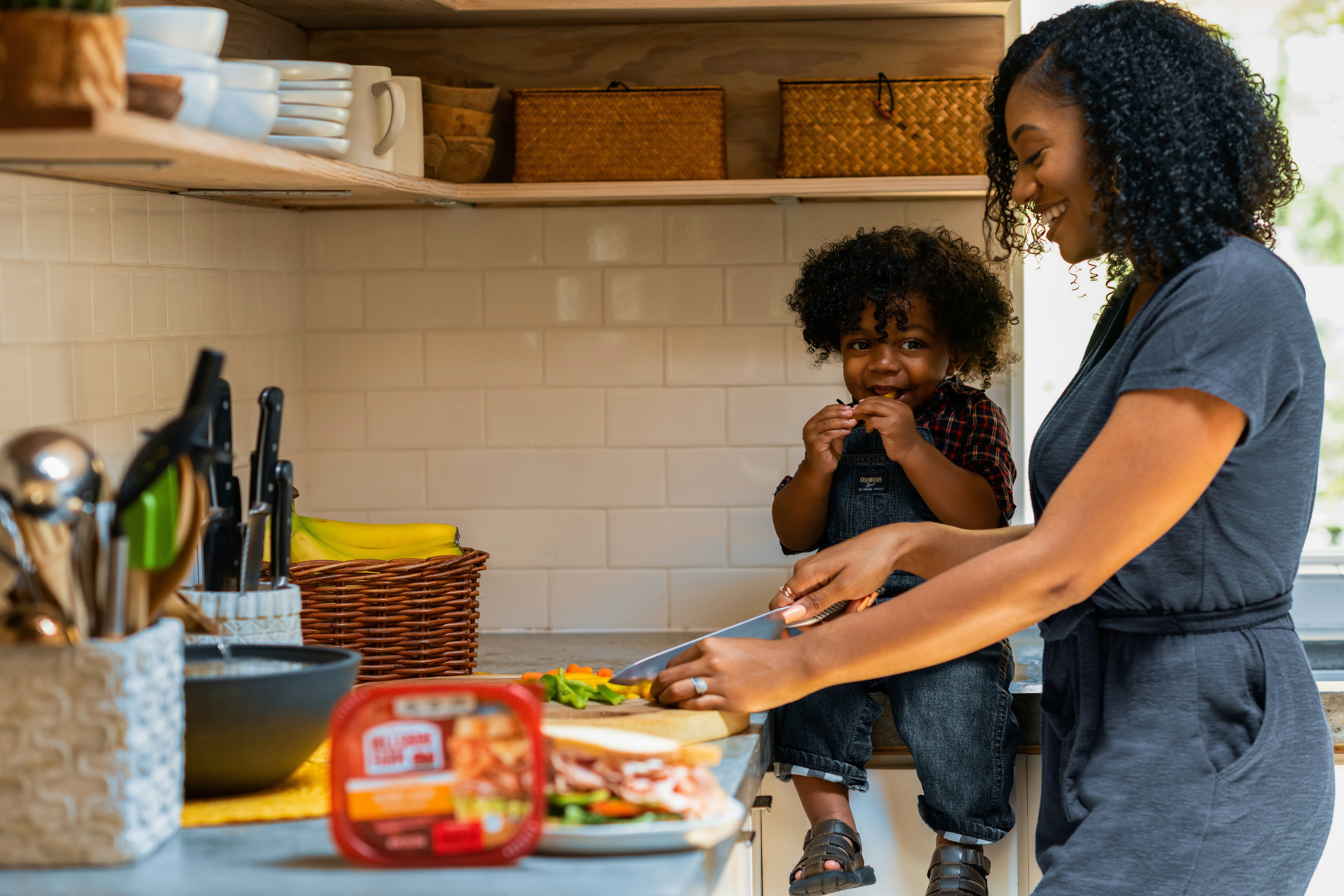 Child and mom cooking in the kitchen