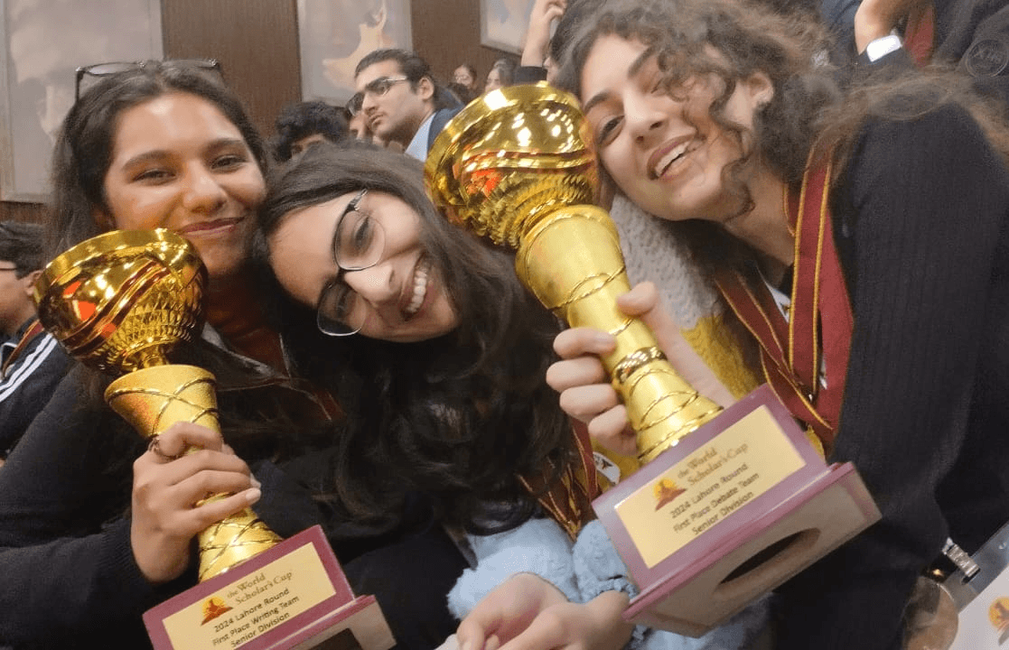 Sarah and her teammates holding up awards they received at a competition