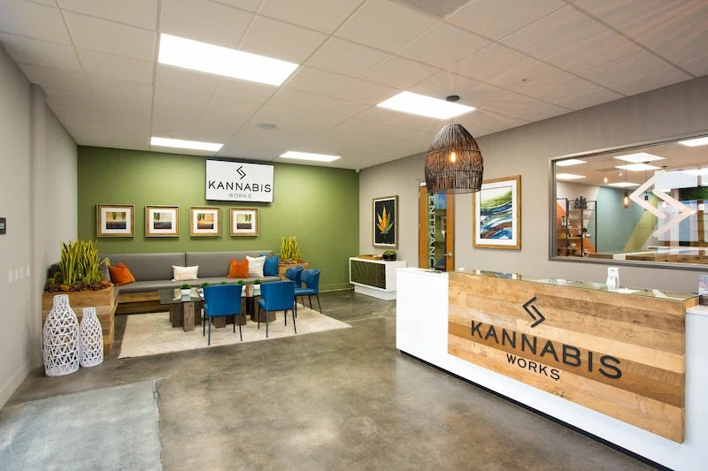 Kannabis Works waiting area with green accent wall, contemporary seating, and artwork. Kannabis Works waiting area with green accent wall, contemporary seating, and artwork.