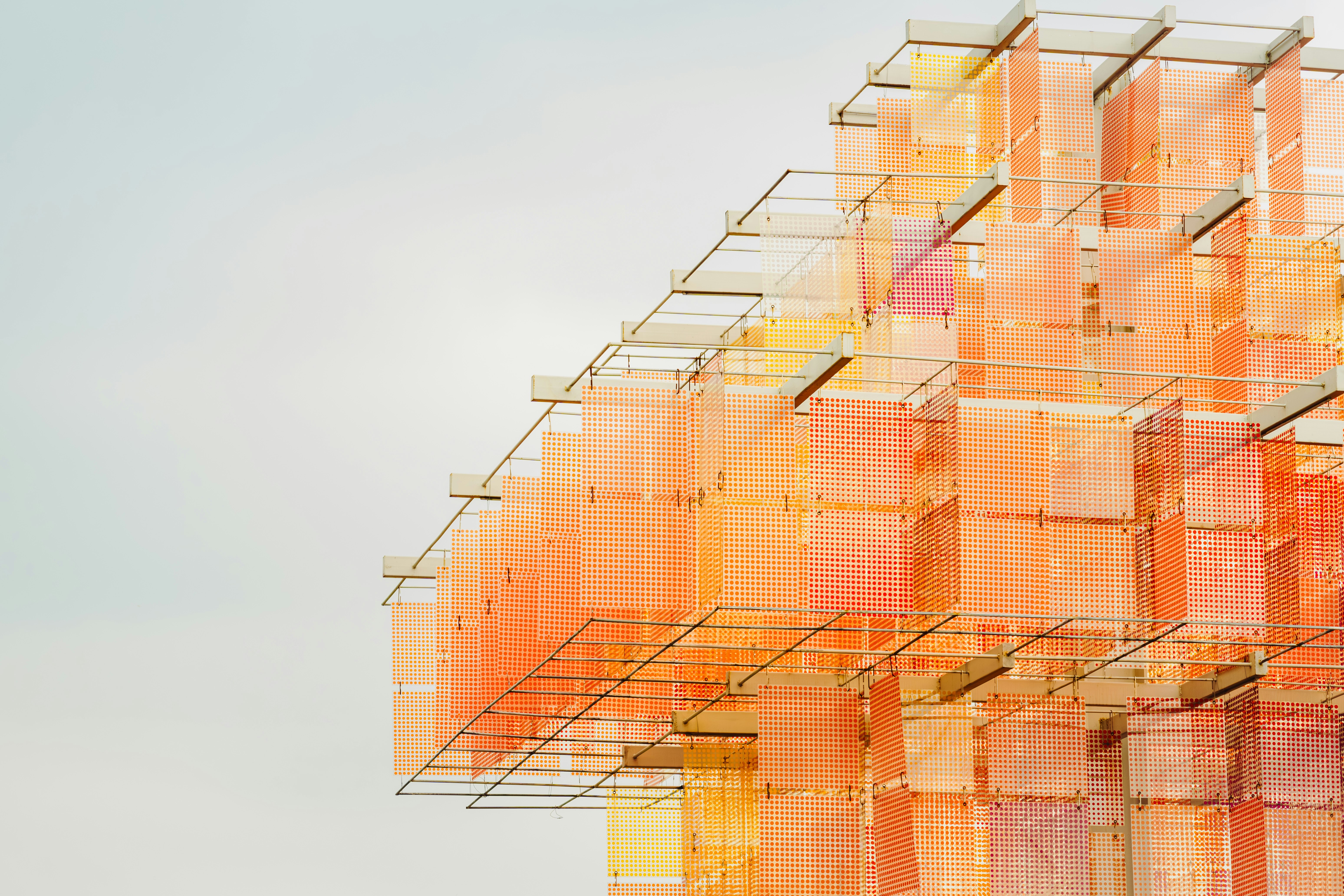 A bronze-colored miniature replica of Auguste Rodin’s sculpture, "The Thinker," positioned against a rustic, light-brown wooden background.