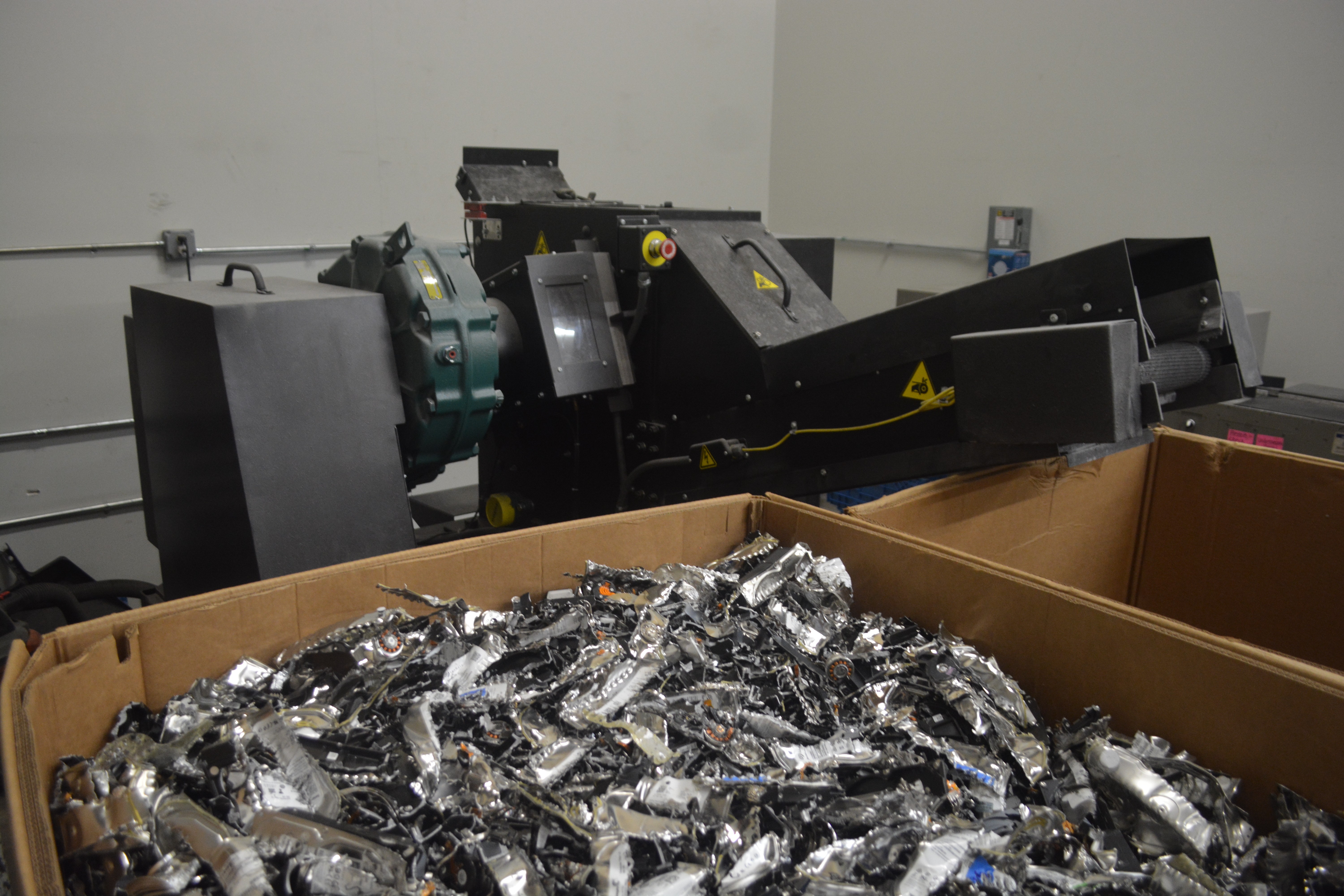 Media destruction machine with container of shredded equipment
