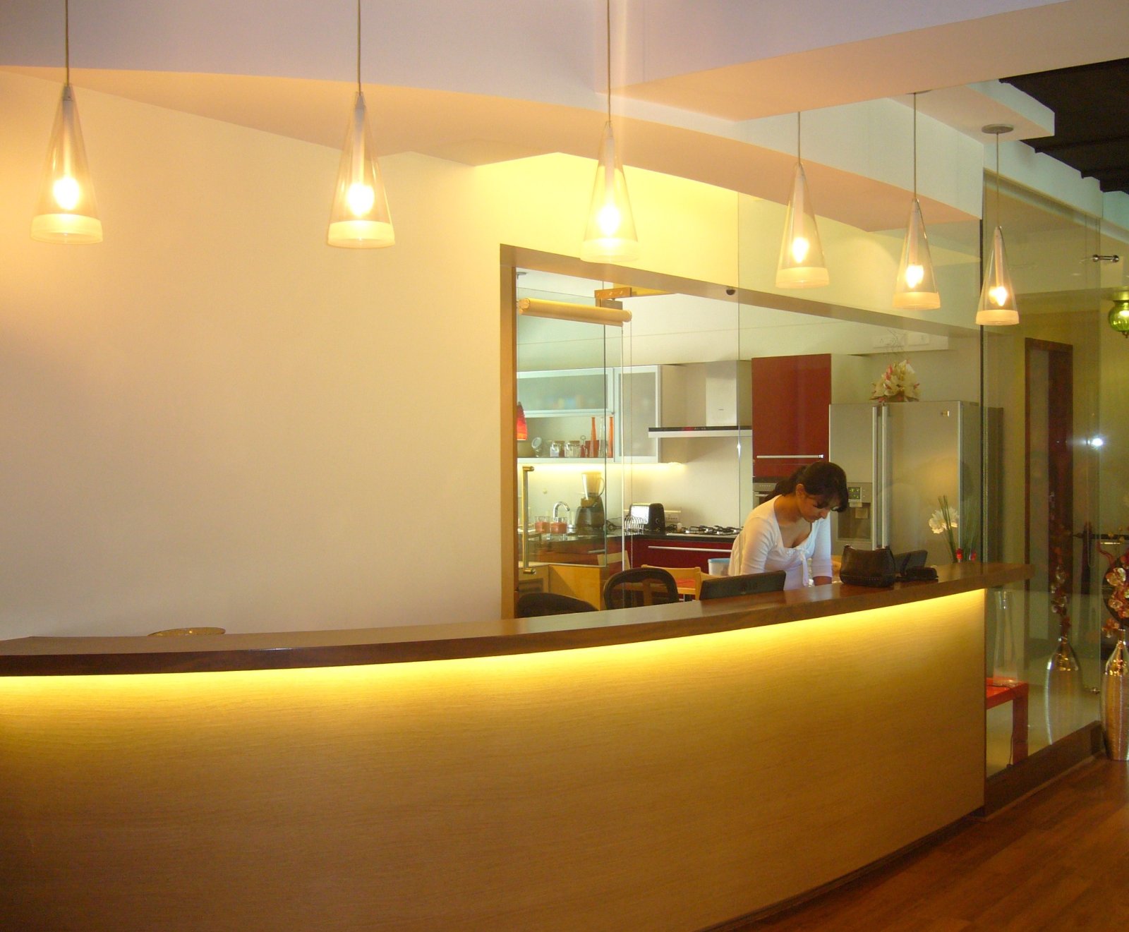 dental clinic reception area with curved illuminated desk and warm lighting