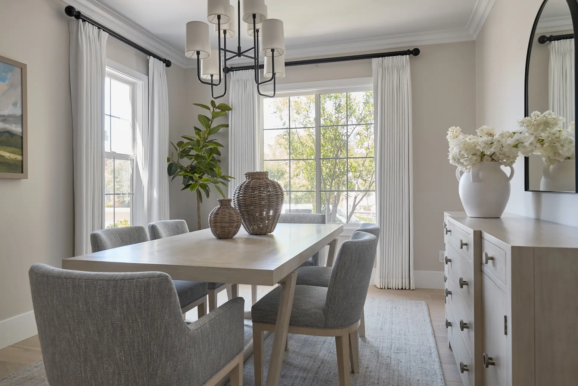 Wide view of the dining room, showcasing the table setup and room design in the Irvine Contemporary Coastal Remodel. Photo by Todd Huge.