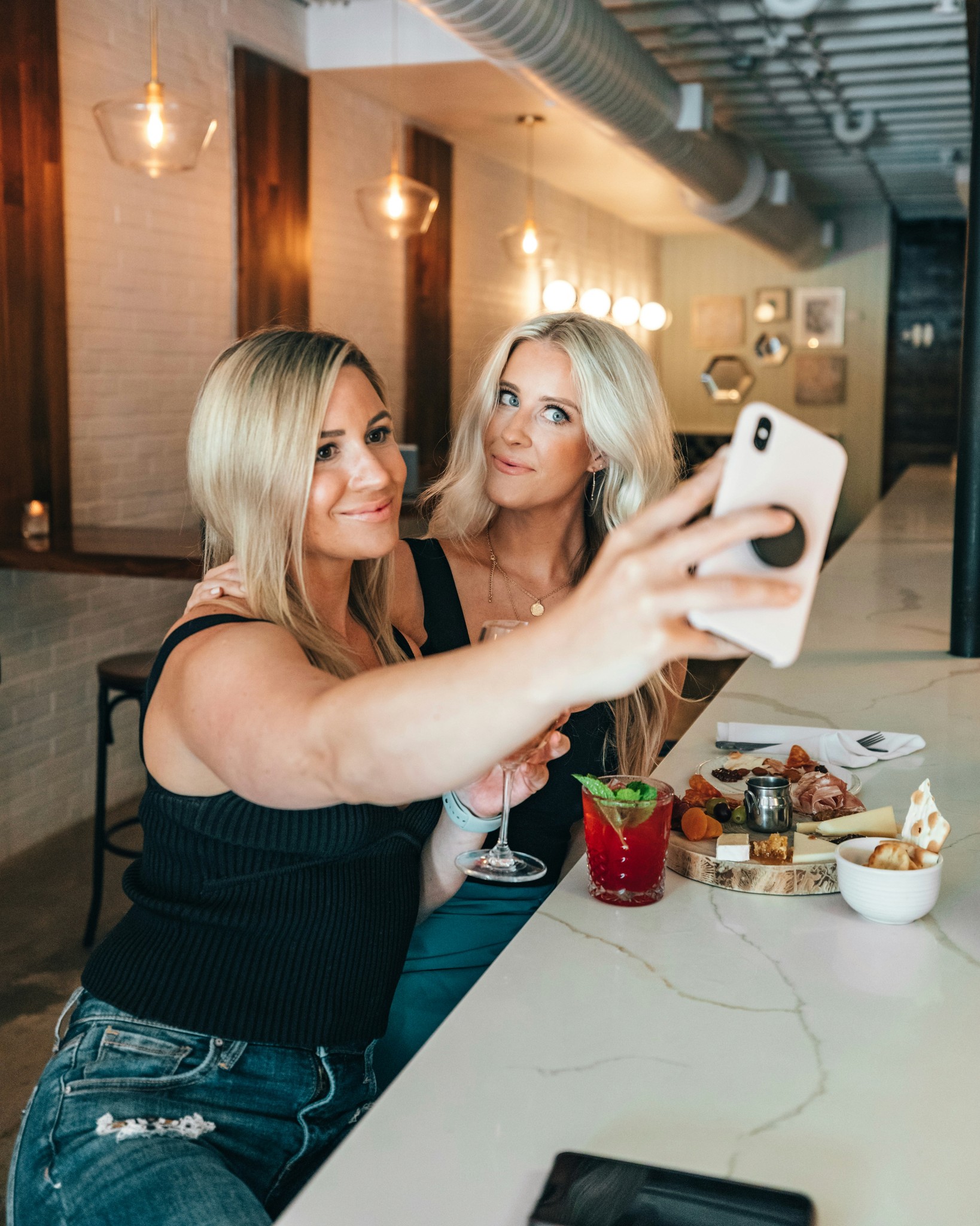 Women leaning against counter taking phone call
