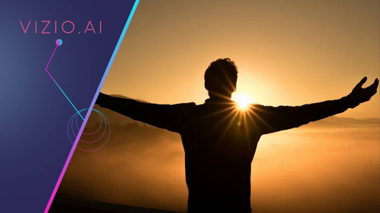 Silhouette of a person standing with arms outstretched against a golden sunrise.