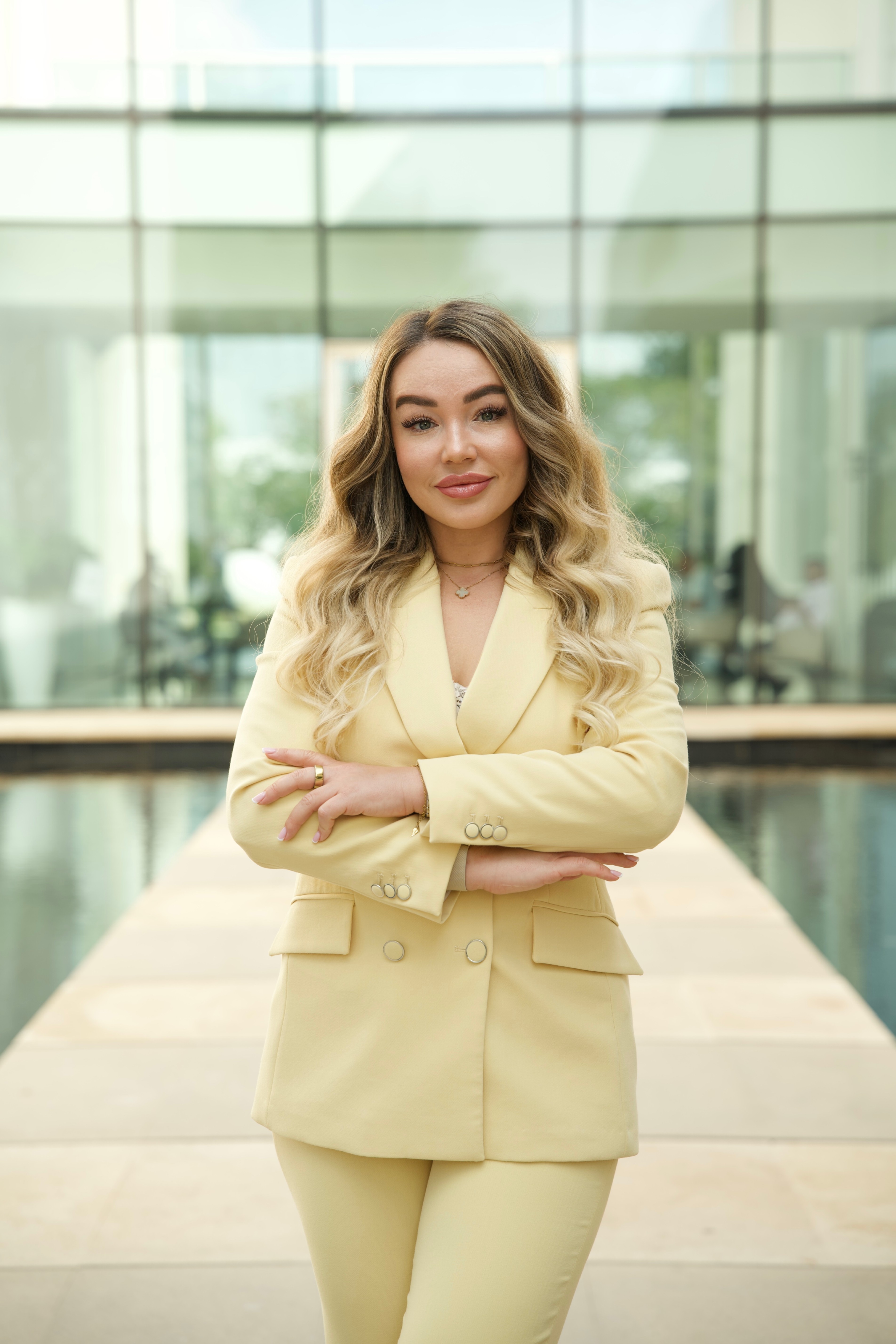Black-and-white party photo of a smiling man in a check blazer among a crowd.