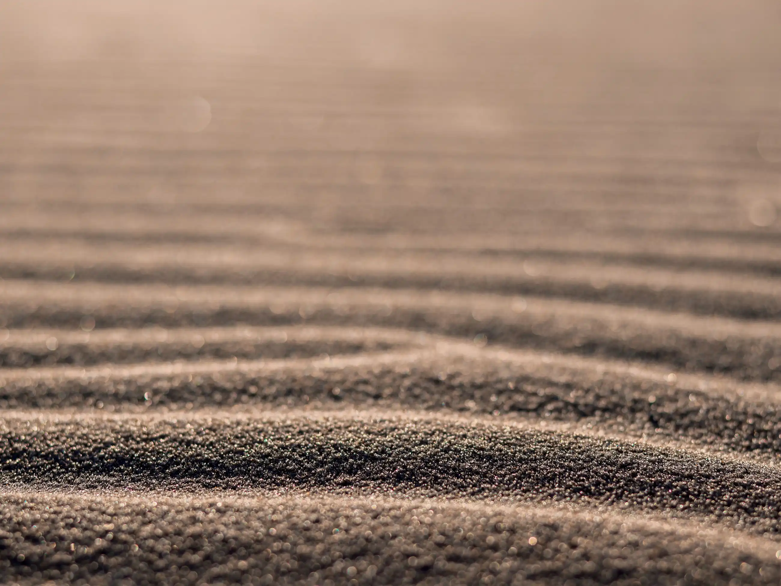 brown sand with water during daytime