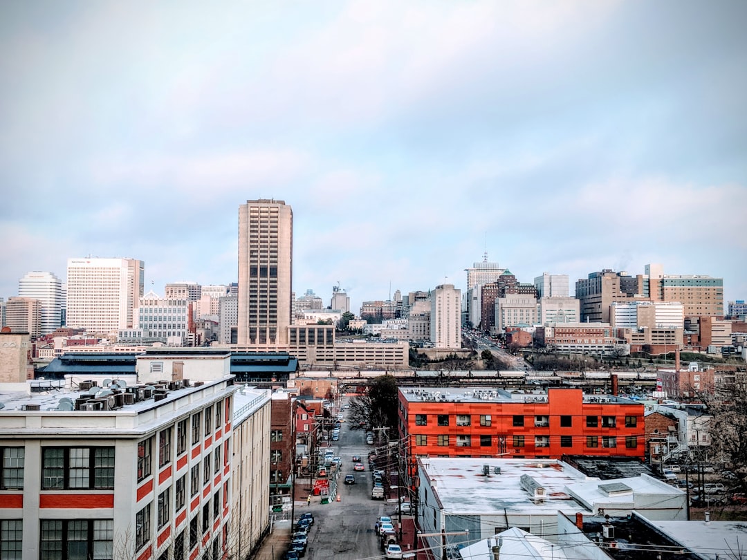Mid-rise downtown skyline with brick buildings and a wide street in the foreground.