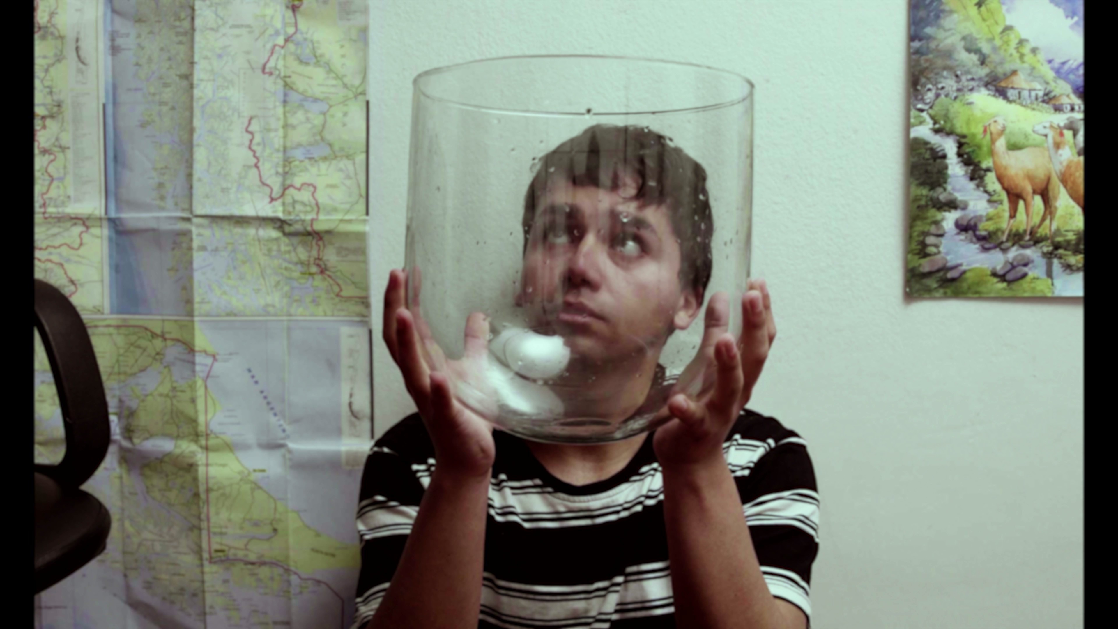 View of the French countryside through a stone villa’s open living room, with sofas and trees framing the scene