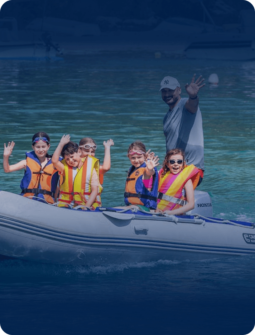 Kids in life jackets on a boat.