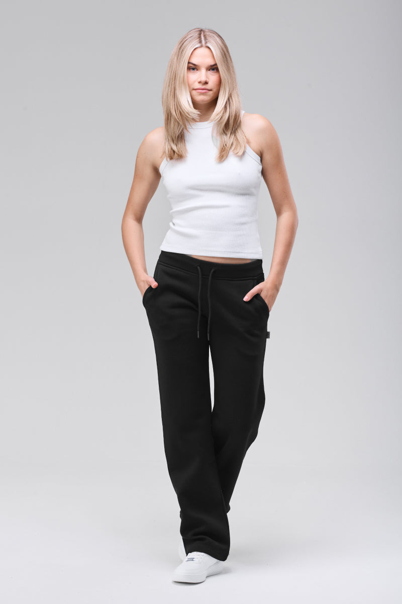 Model wearing black straight leg sweatpants, full figure
