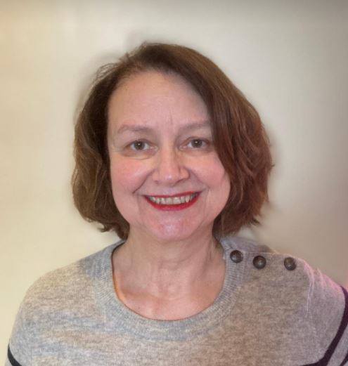 man smiling while sitting on floor during daytime