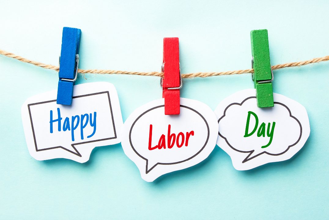 Happy Labor Day message cards with red, blue, and green clothespins on a twine string, festive employee appreciation concept for corporate celebration.