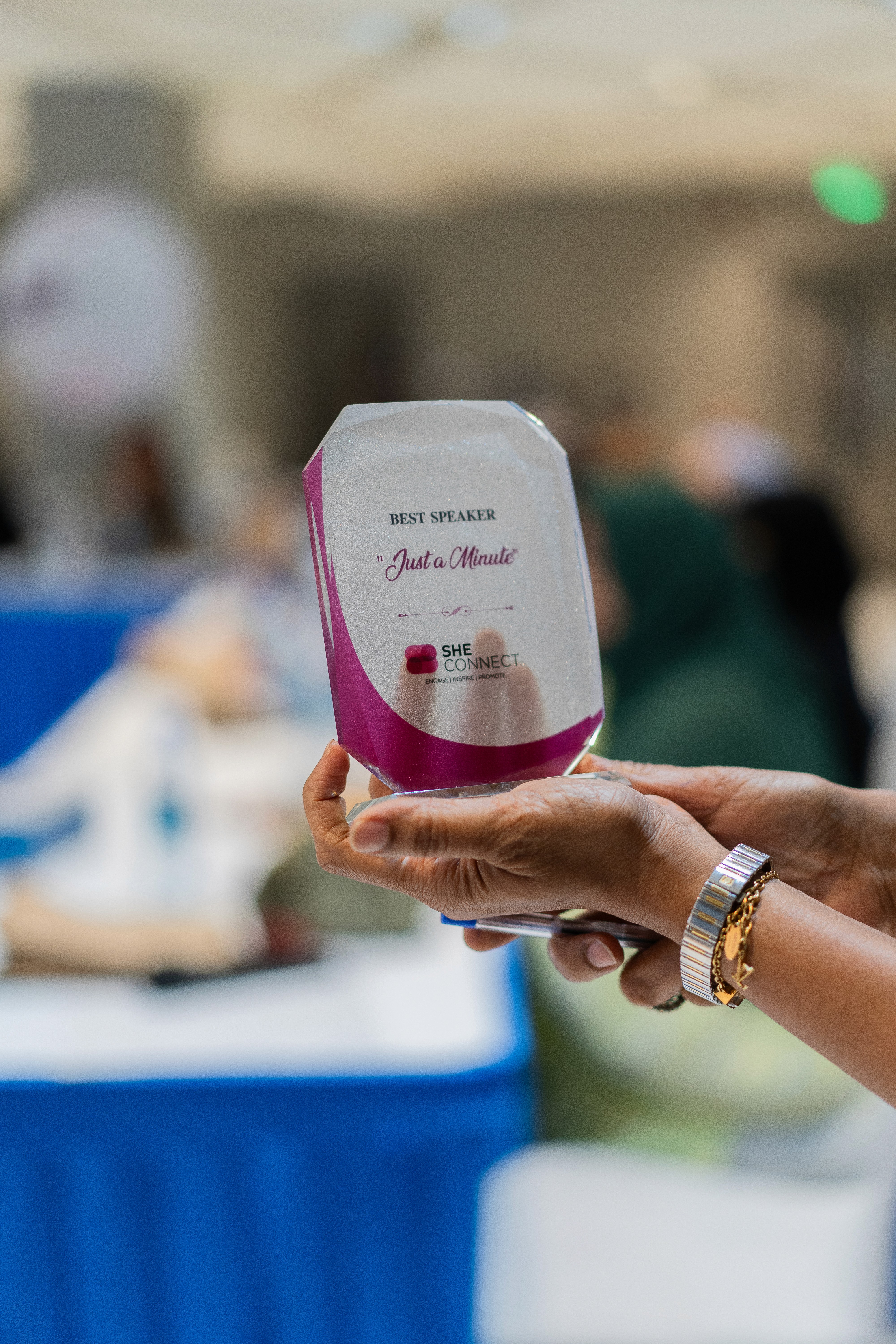 Close-up of a dark green leaf showing its textured surface and central vein against a muted background.