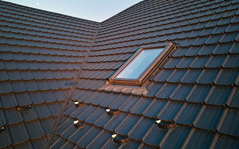 a kitchen with white cabinets and marble counter tops