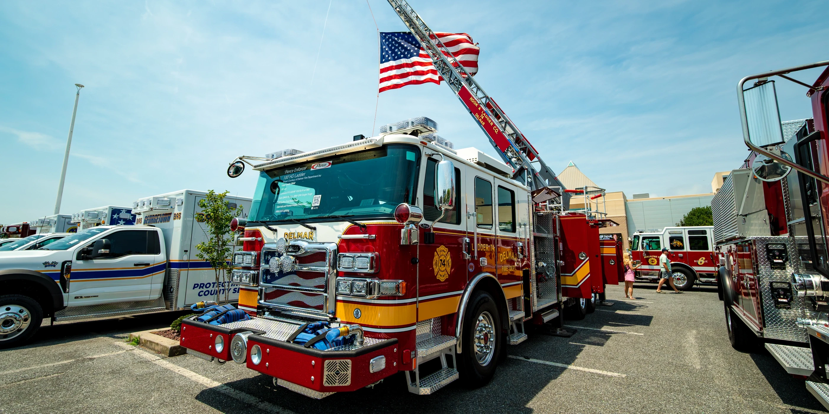 Firefighters beside apparatus