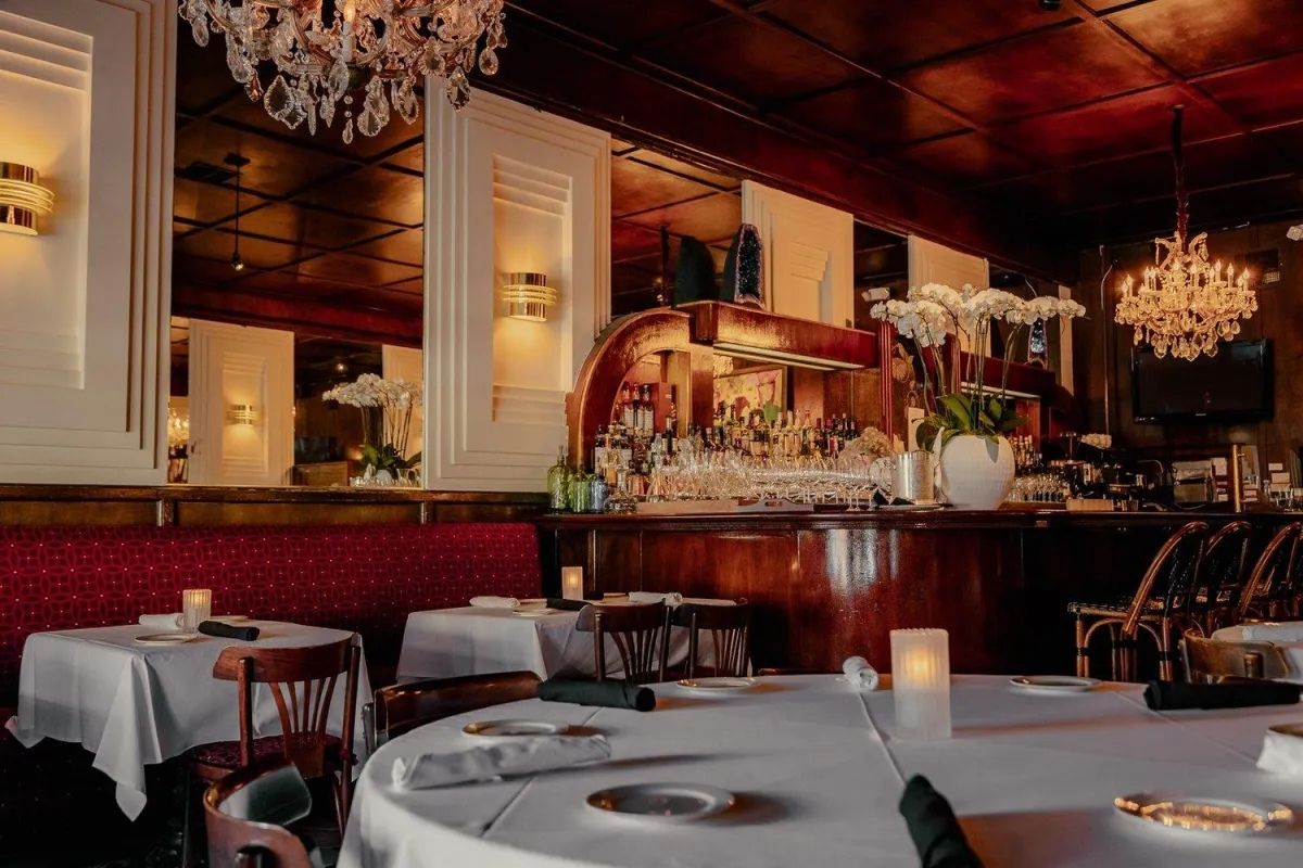 Mistral Sherman Oaks interior dining room with romantic lighting and classic French bistro decor.