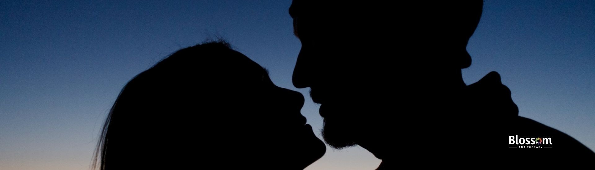 The silhouette of a couple facing each other.