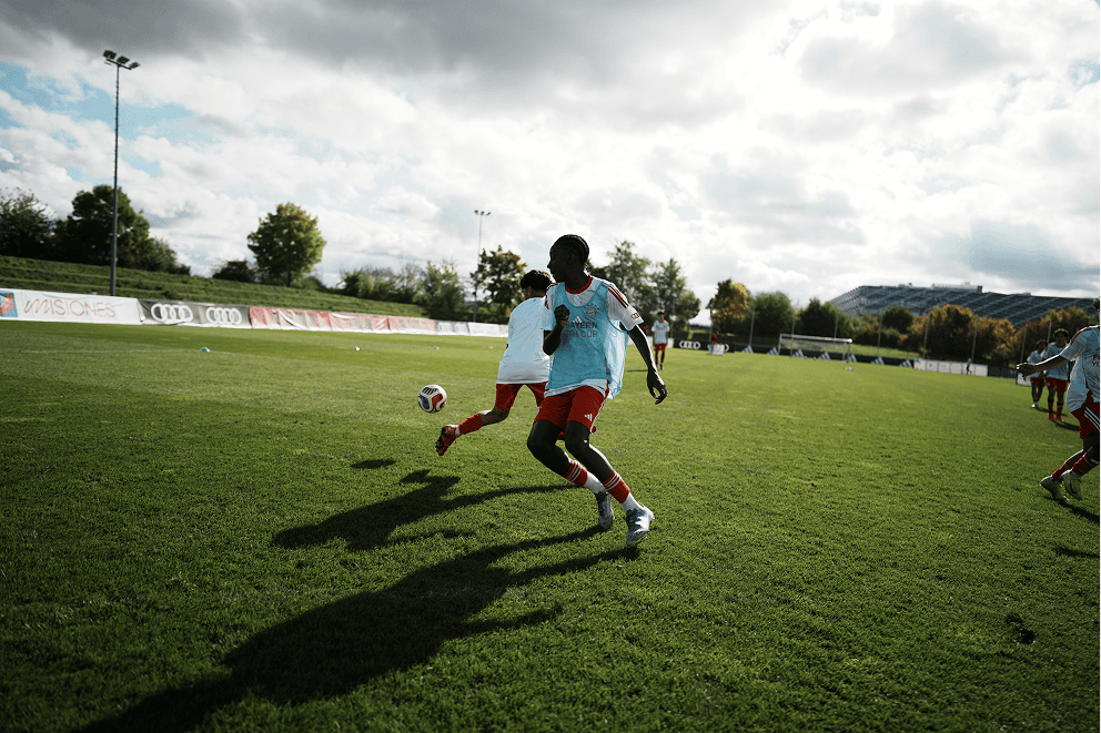 two footballers chasing the ball