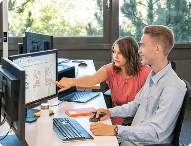 Sovendus employees working with dual screens in the modern Sovendus office