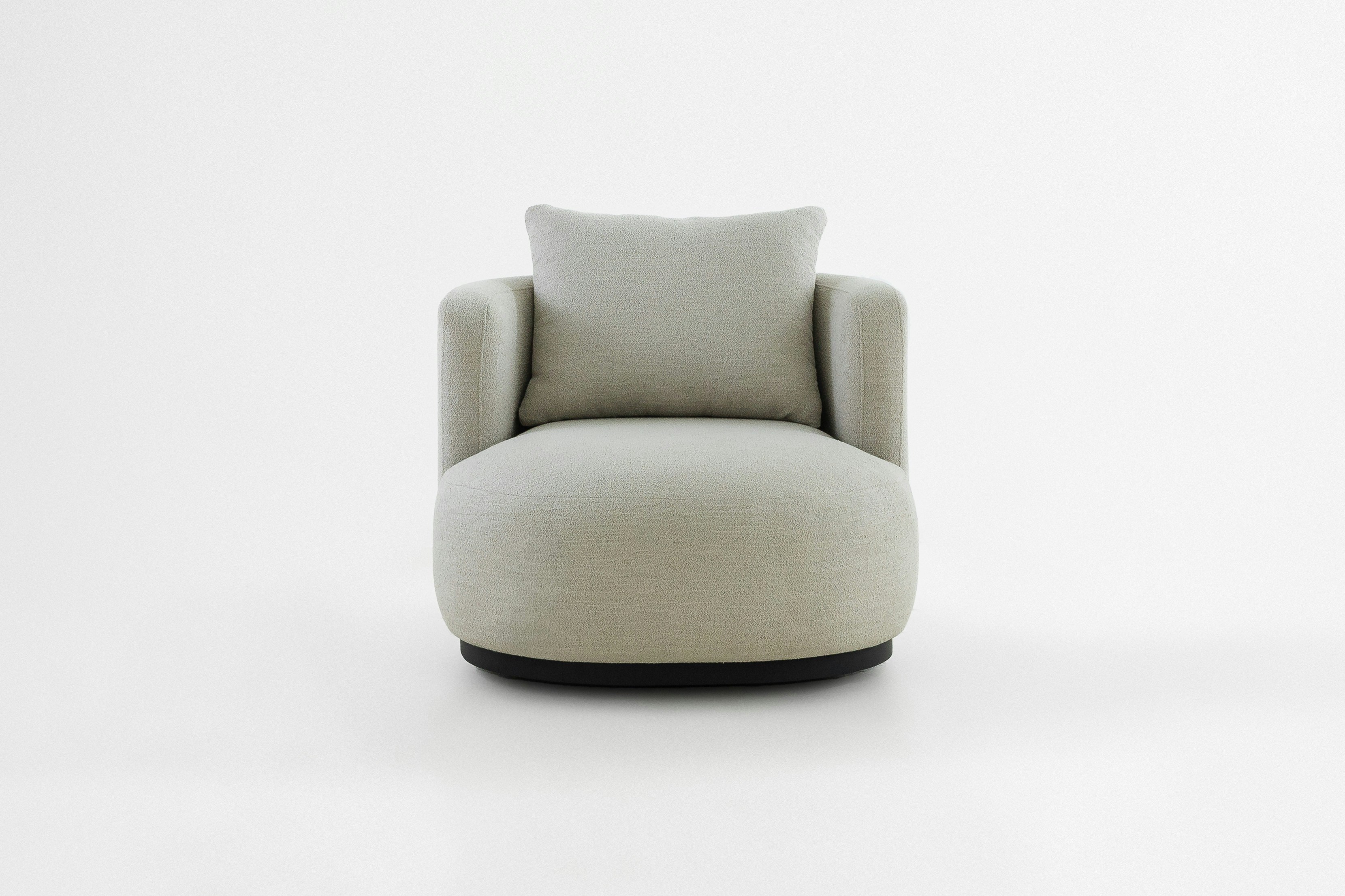 Cozy, modern armchair centered against a white backdrop.