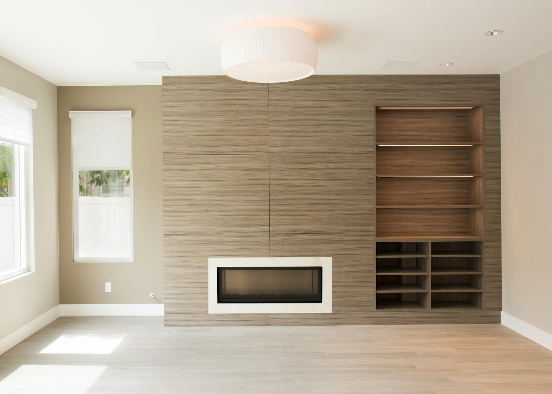 View of the 1st guest bedroom's fireplace wall, showcasing a blend of modern style and cozy ambiance in the Harbor Cove remodel.