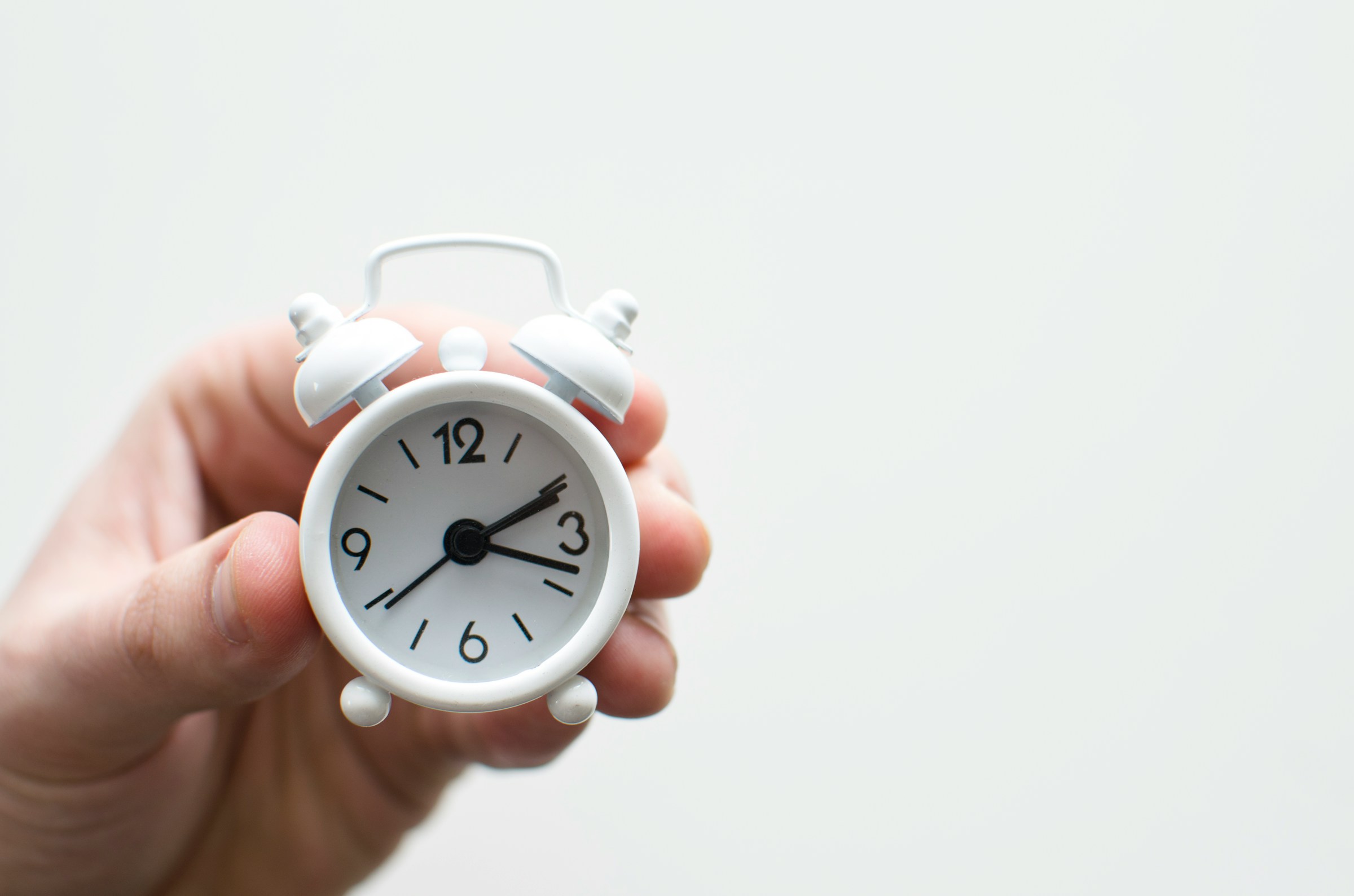 person holding a clock - How Long Does It Take To Write A Research 