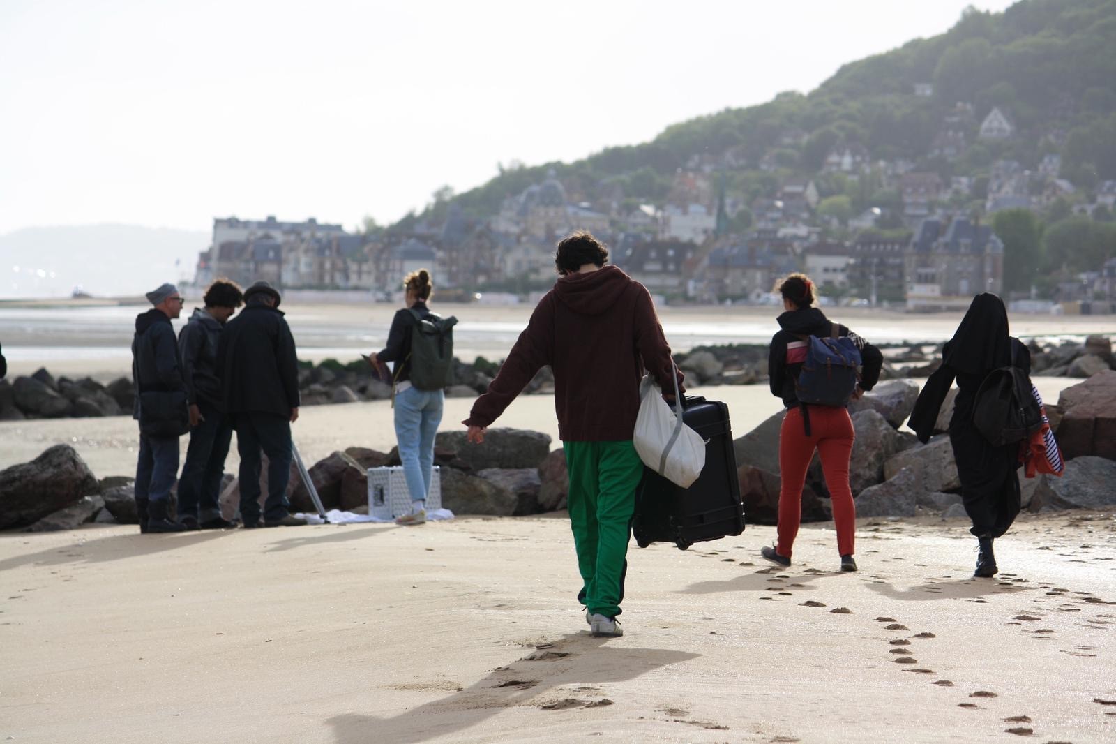 Athletes resting on a track after training.
