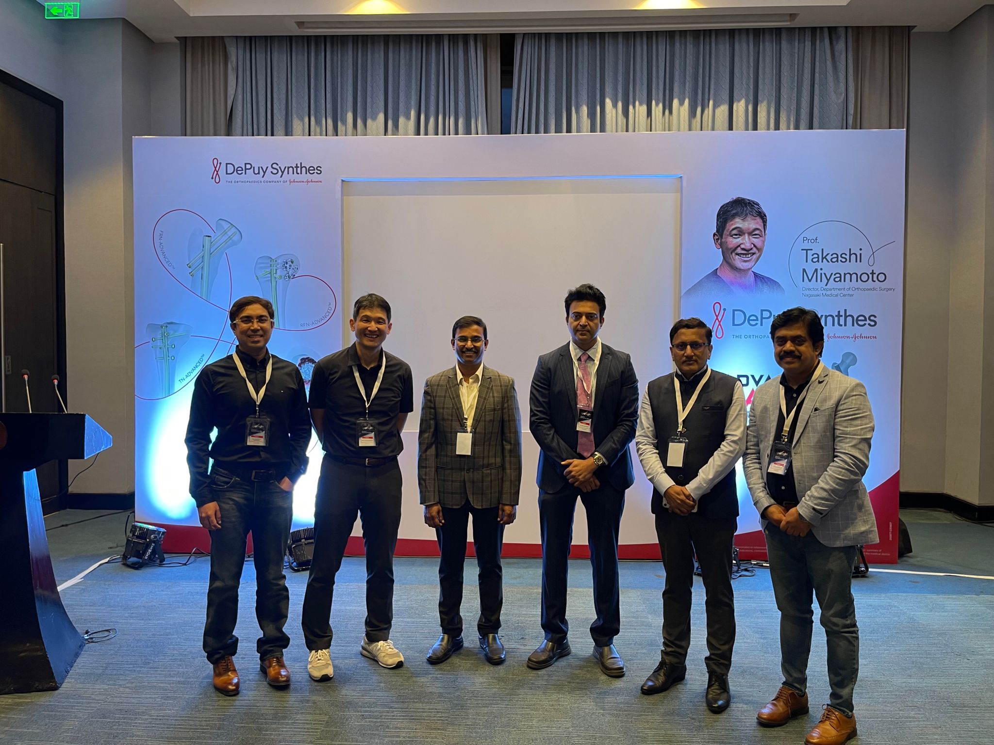 A fantasy fairy figure with wings made of red and pink petals under a full moon