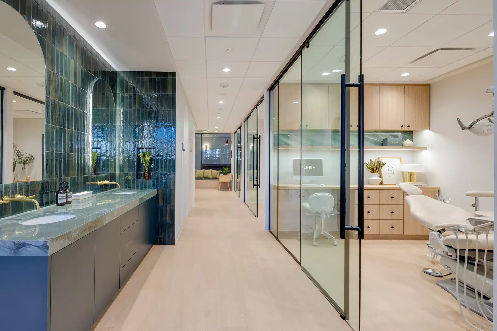 Interior hallway of Alinea Orthodontics clinic showing glass treatment rooms and clean modern clinic design.