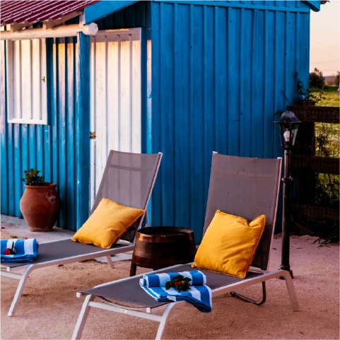 a row of lounge chairs sitting next to a swimming pool