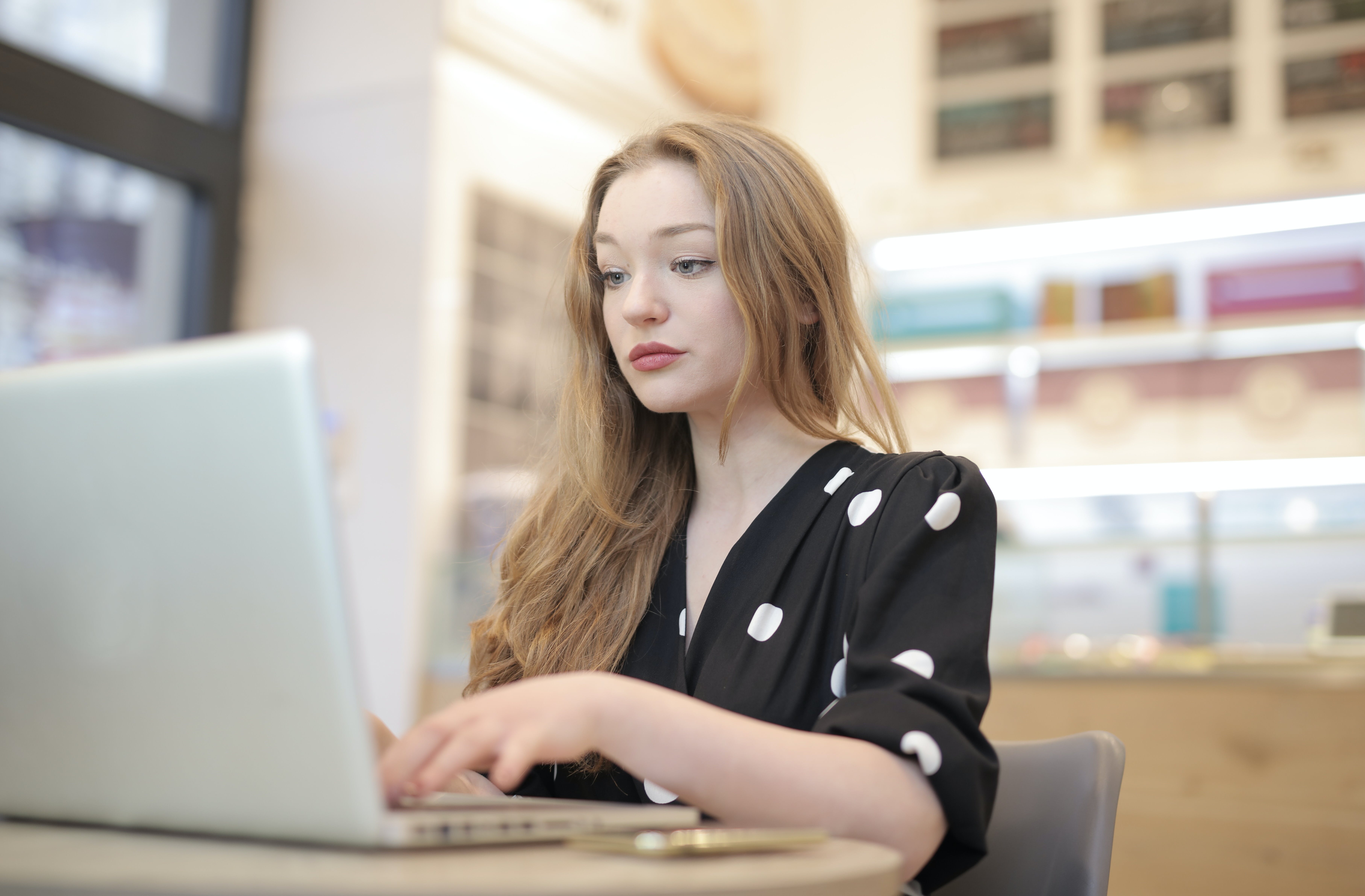 Woman using silver laptop boosting cold email success rate