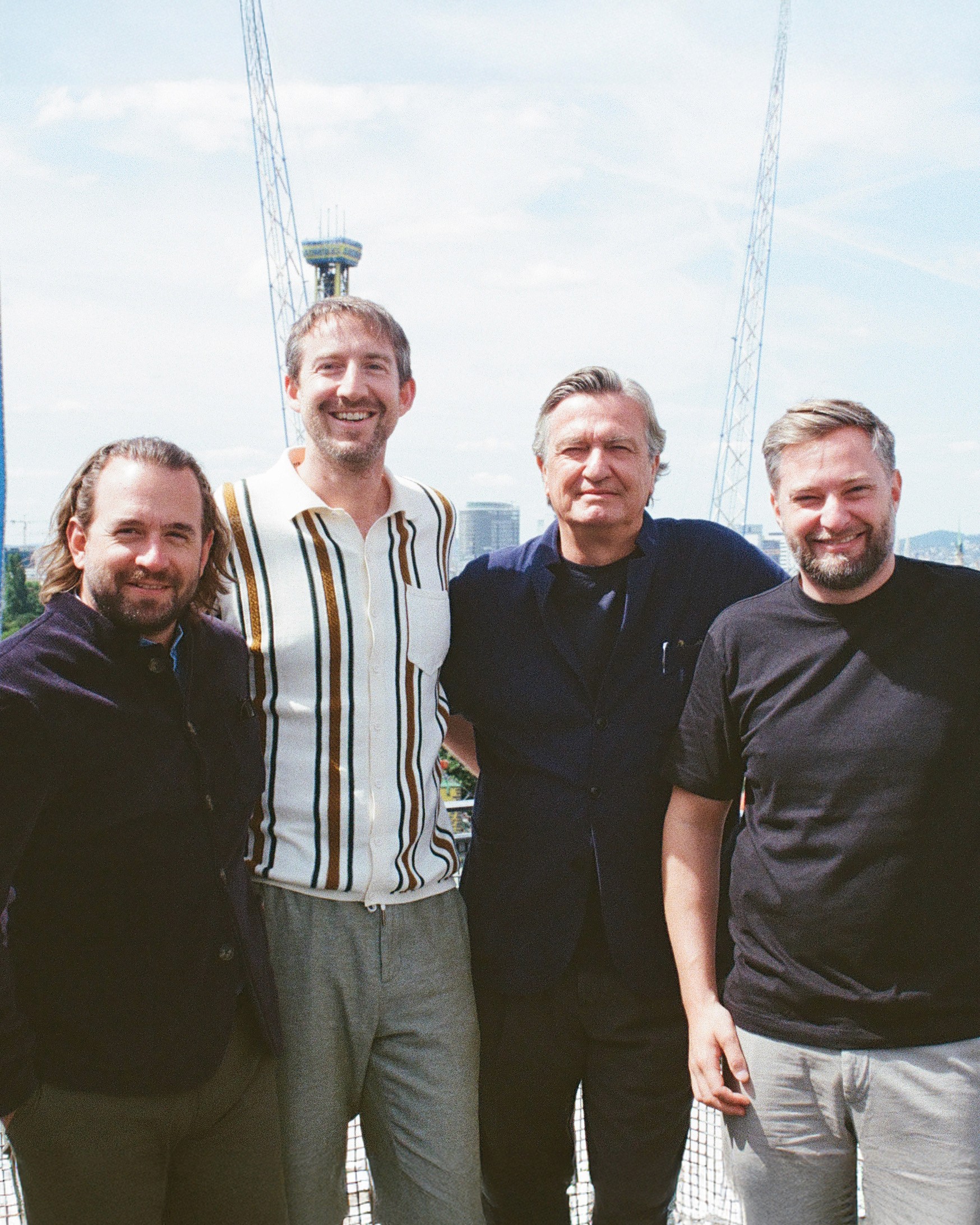 Photo of the four founders of The Companion Hotels in front of blue skies