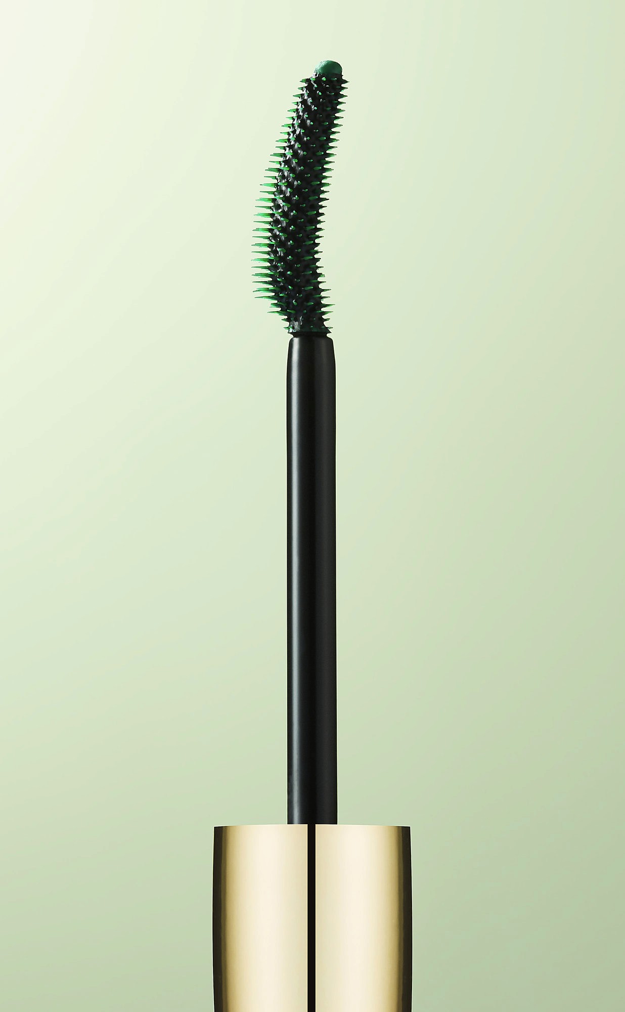 A stylized illustration of a green, curved tool with a wooden handle, set against a soft green background.
