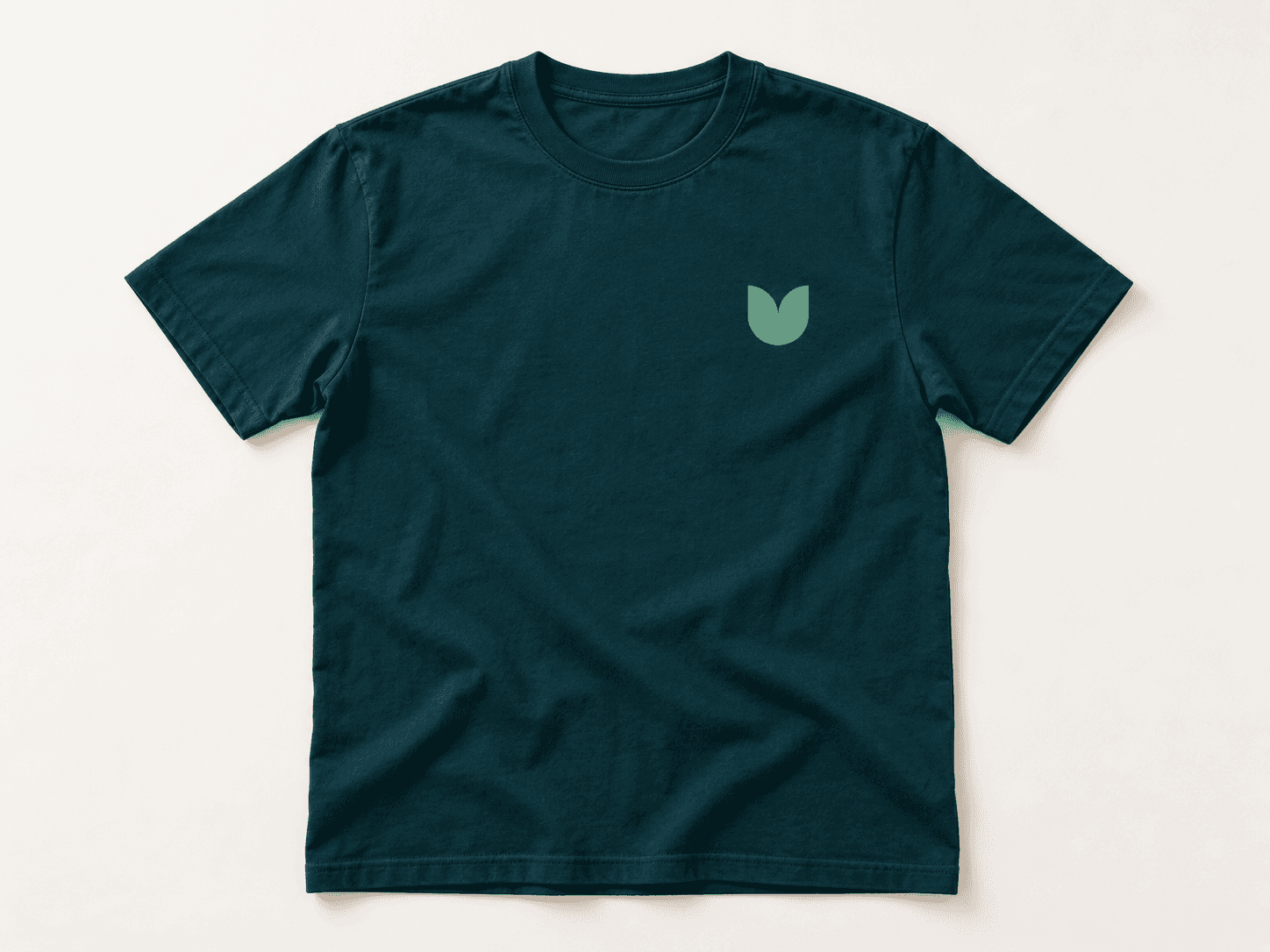 Garden logo application on a dark teal cotton T-shirt