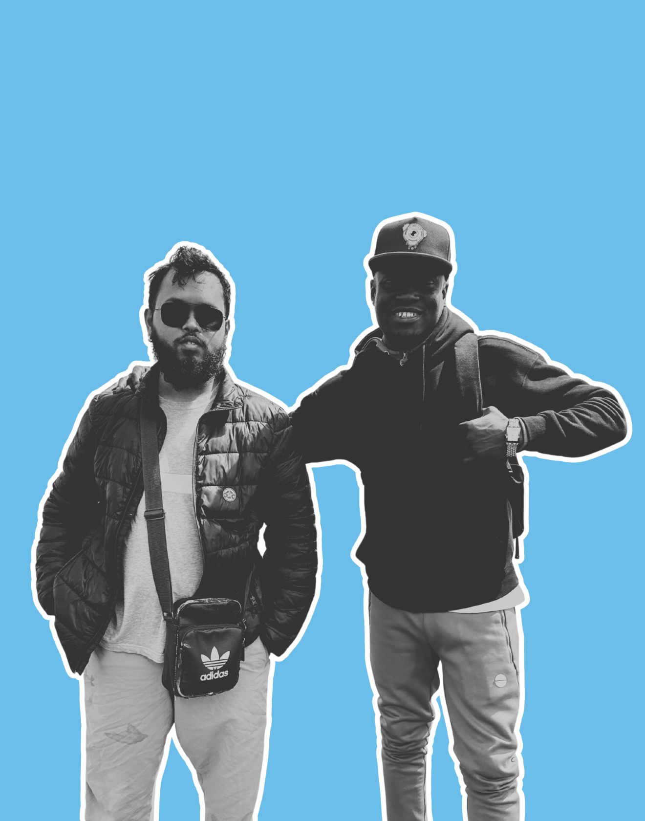 man in gray hoodie and blue denim jeans standing on brown wooden parquet flooring