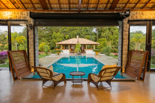 Tropical resort villa with a private pool and lounge chairs, illustrating a high-value booking that needs protection from no-shows via deposits.
