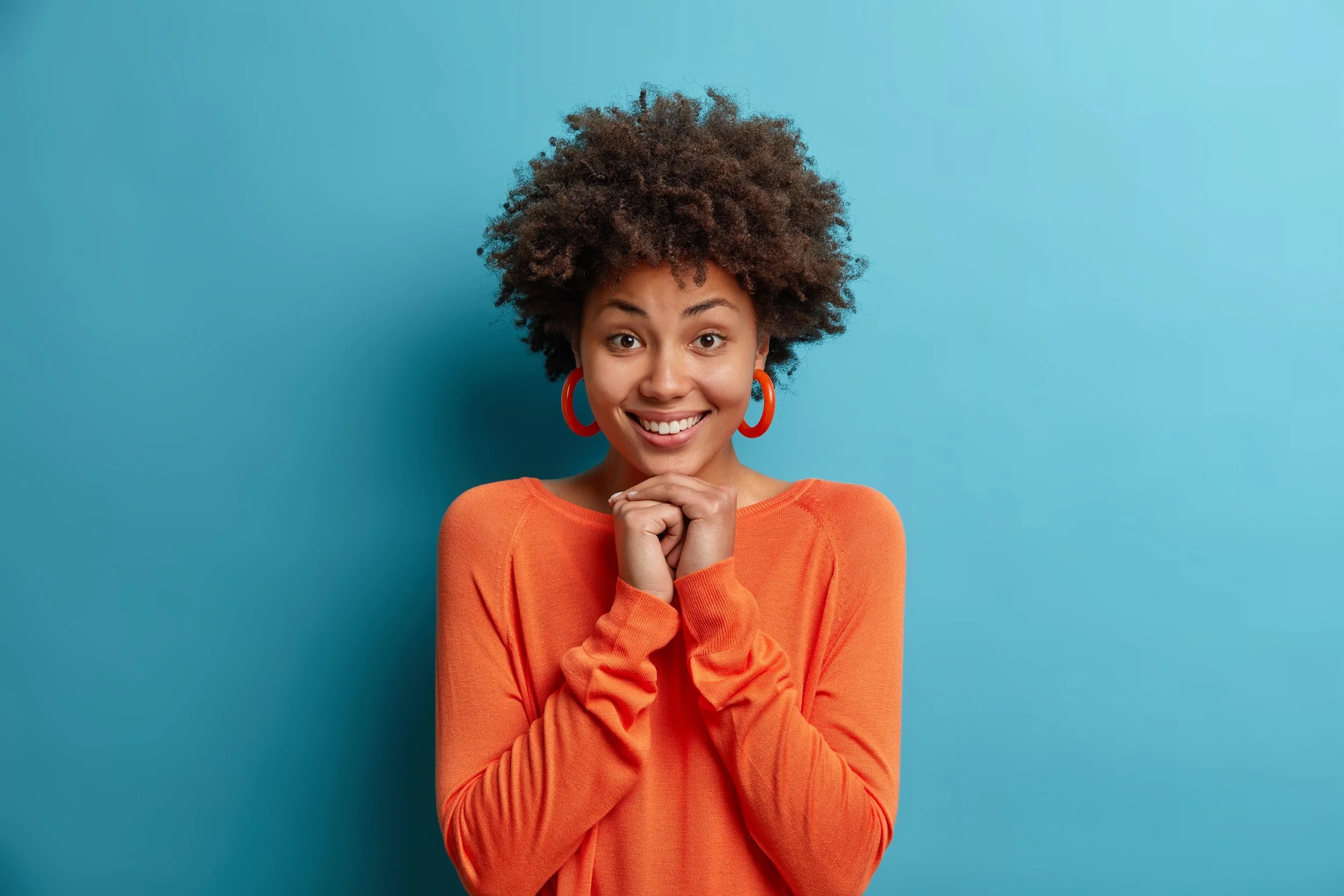 Woman excited against a blue backdrop