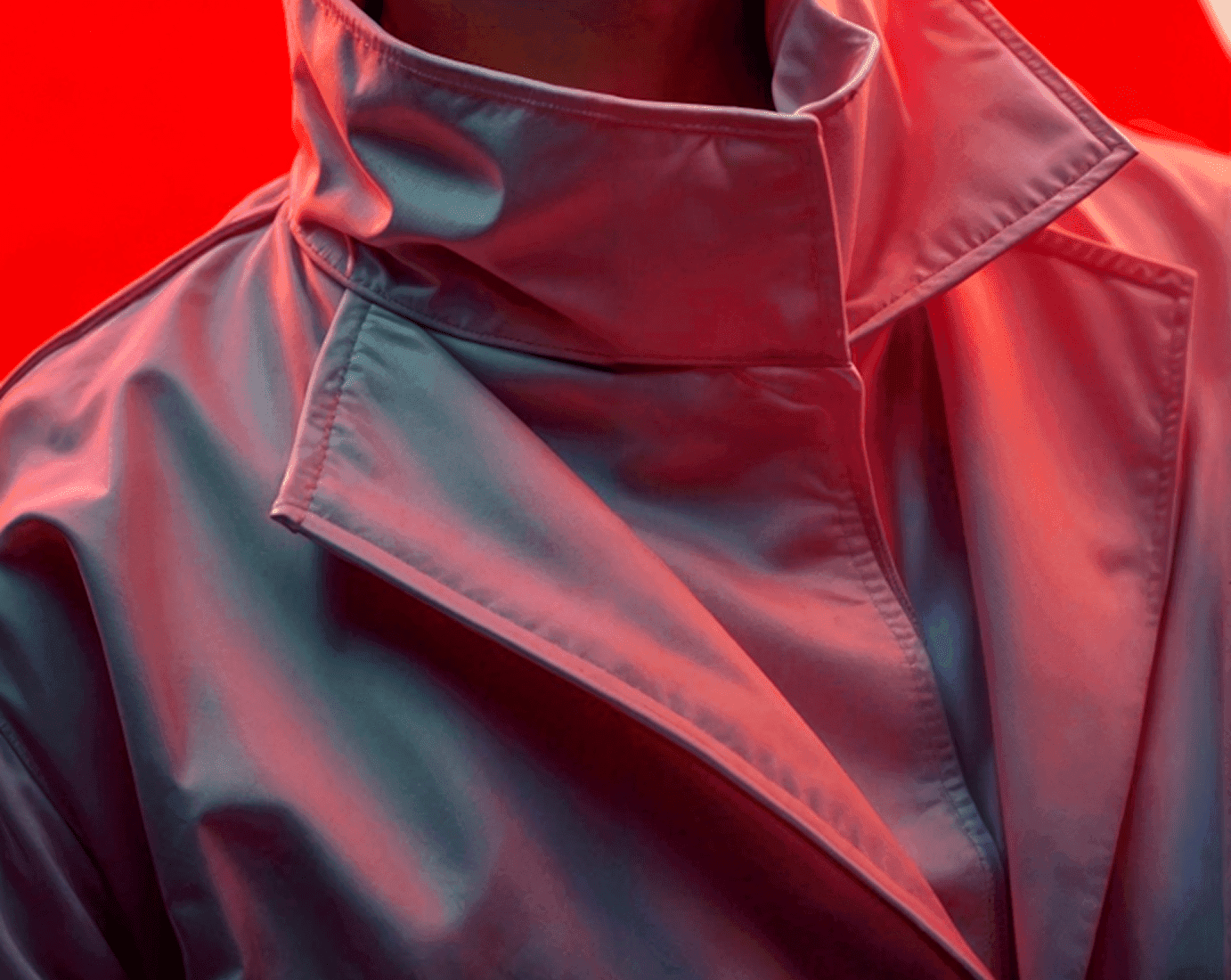 Close-up of a person wearing a stylish jacket, showcasing the fabric texture and design details.