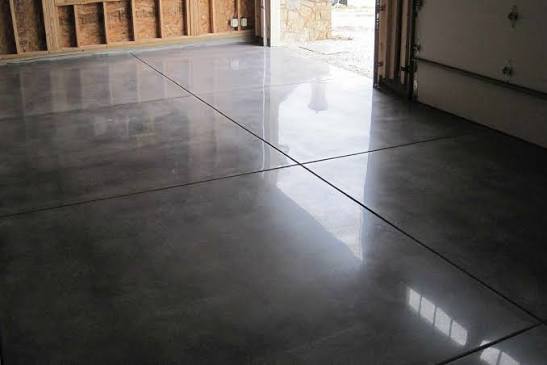 Polished, glossy concrete floor with joints in a garage.