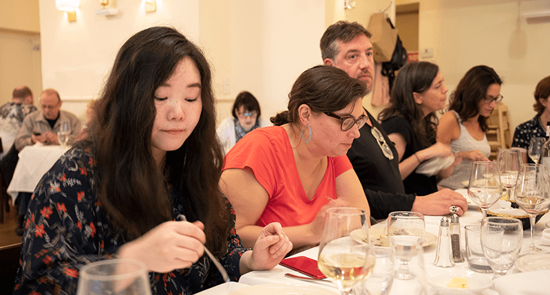 photo of people sitting at a restaurant table