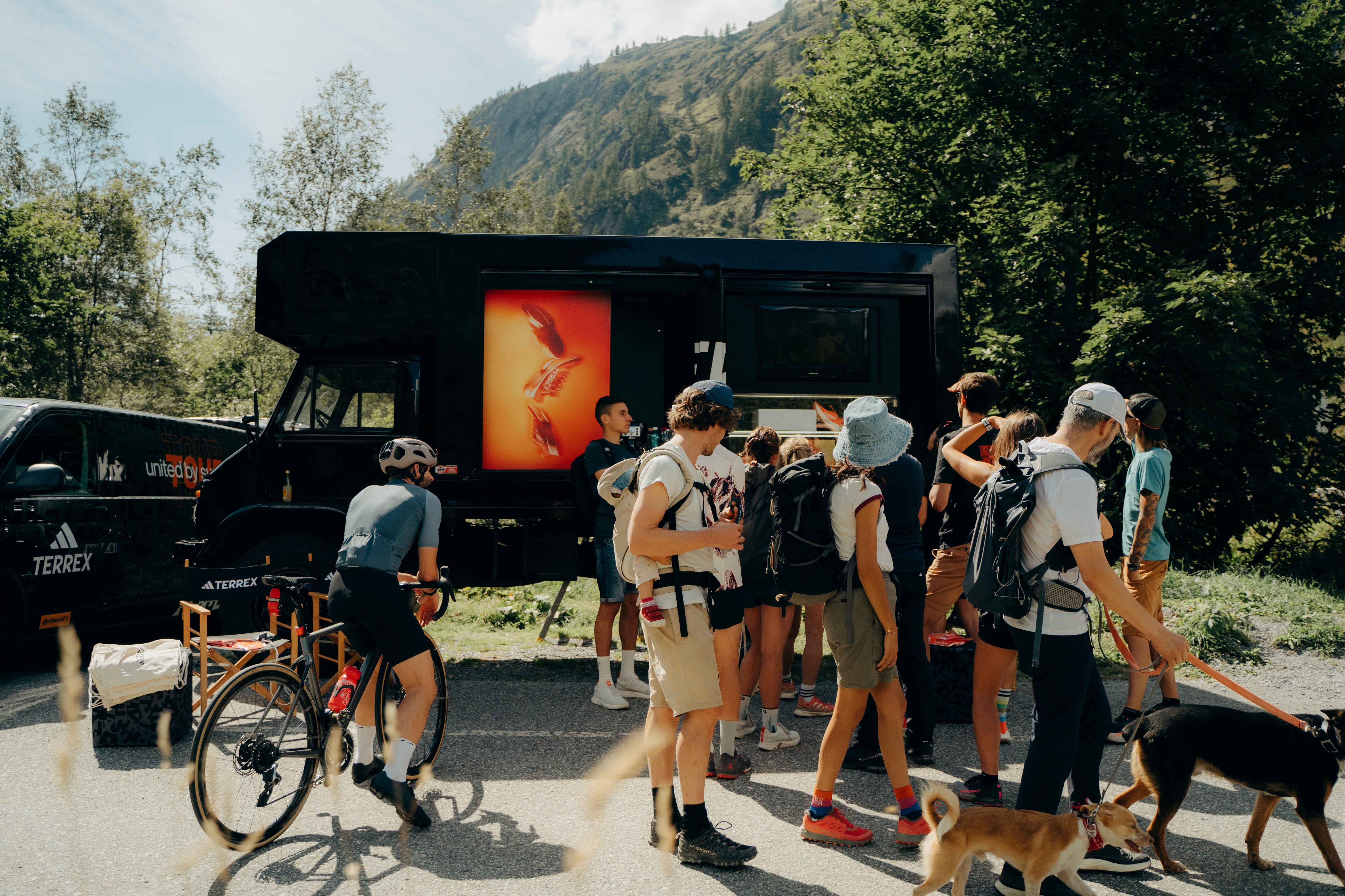 HERO Bike and Adidas Terrex truck at an outdoor event in Chamonix with crowd and open-air activities
